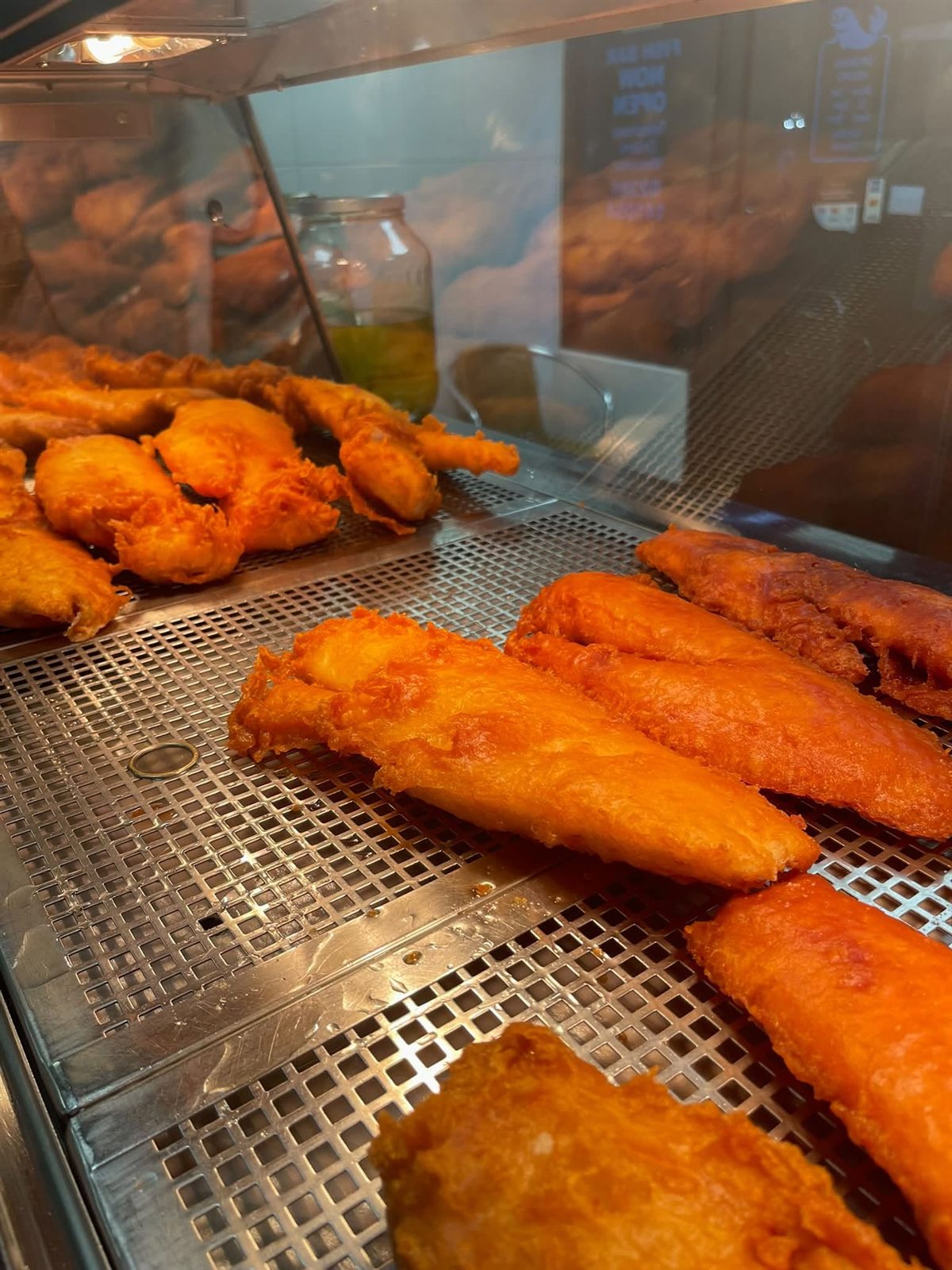 Battered fish fillets in the hot display cabinet
